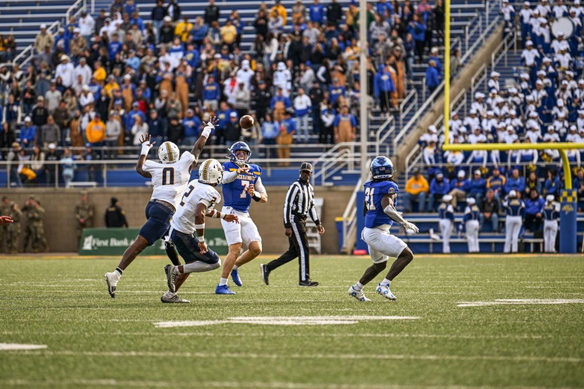 SDSU backup quarterback Chase Mason throws the football to Angel Johnson while under pressure. Both Angel Johnson and Mason are 2021 graduates of Viborg-Hurley High School in South Dakota