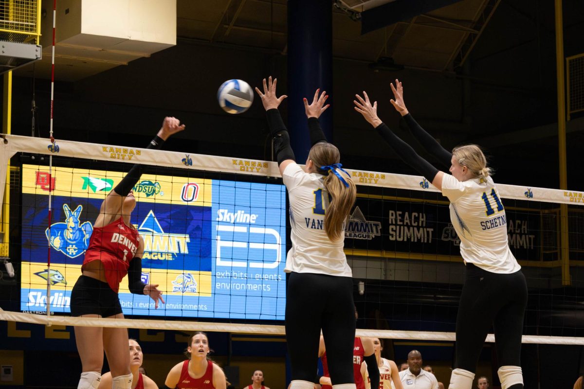 SDSU's Katie Van Egdom (16) and Sydni Schetnan (11) go up for a block attempt during a Summit League Tournament game against the Denver Pioneers on Monday, Nov. 25, 2024 at the Swinney Recreation Center in Kansas City.