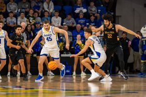 Redshirt freshman Joe Sayler and Washington State transfer Oscar Cluff chase down a loose ball.