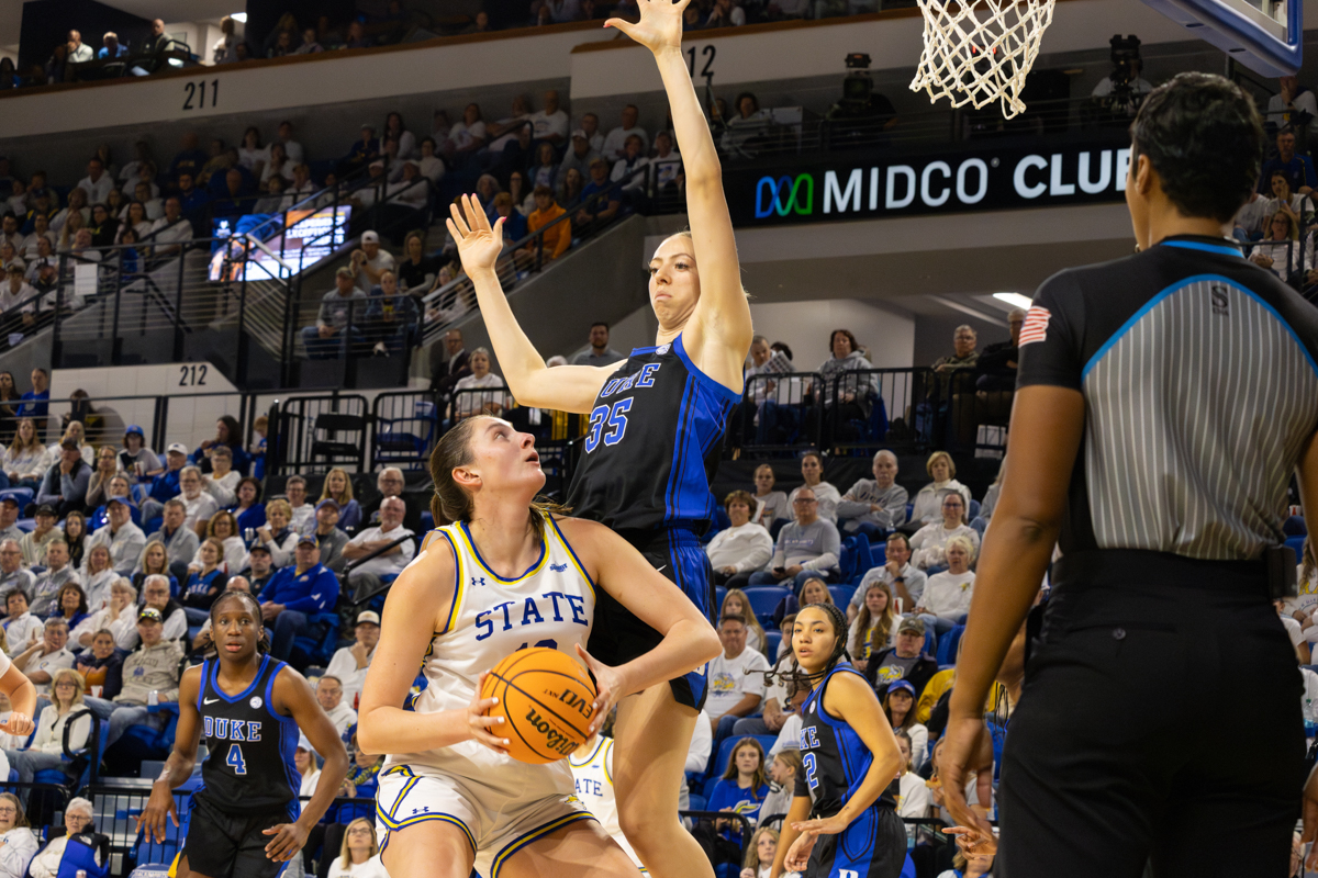 Kallie Theisen attempts a shot with Duke forward Toby Fournier defending the net. Fournier recorded a block in the 75-71 Duke victory.