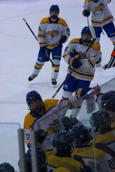 Quintin Steindl celebrates with the team after a goal in their victory against Augustana.