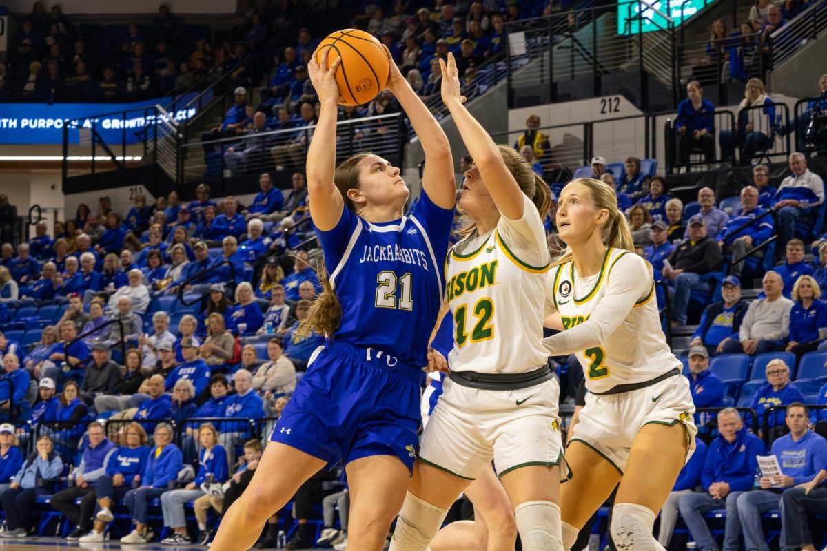 SDSU's Paige Meyer leans into a shot while NDSU's Marisa Frost defends Wednesday night at First Bank & Trust Area. Meyer had 13 points shooting 6-for-11 from the field in a 63-55 win over the rival Bison.