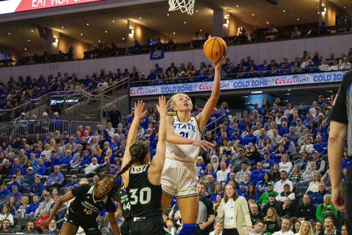 Brookyln Meyer driving into the paint against North Dakota's Jocelyn Schiller.