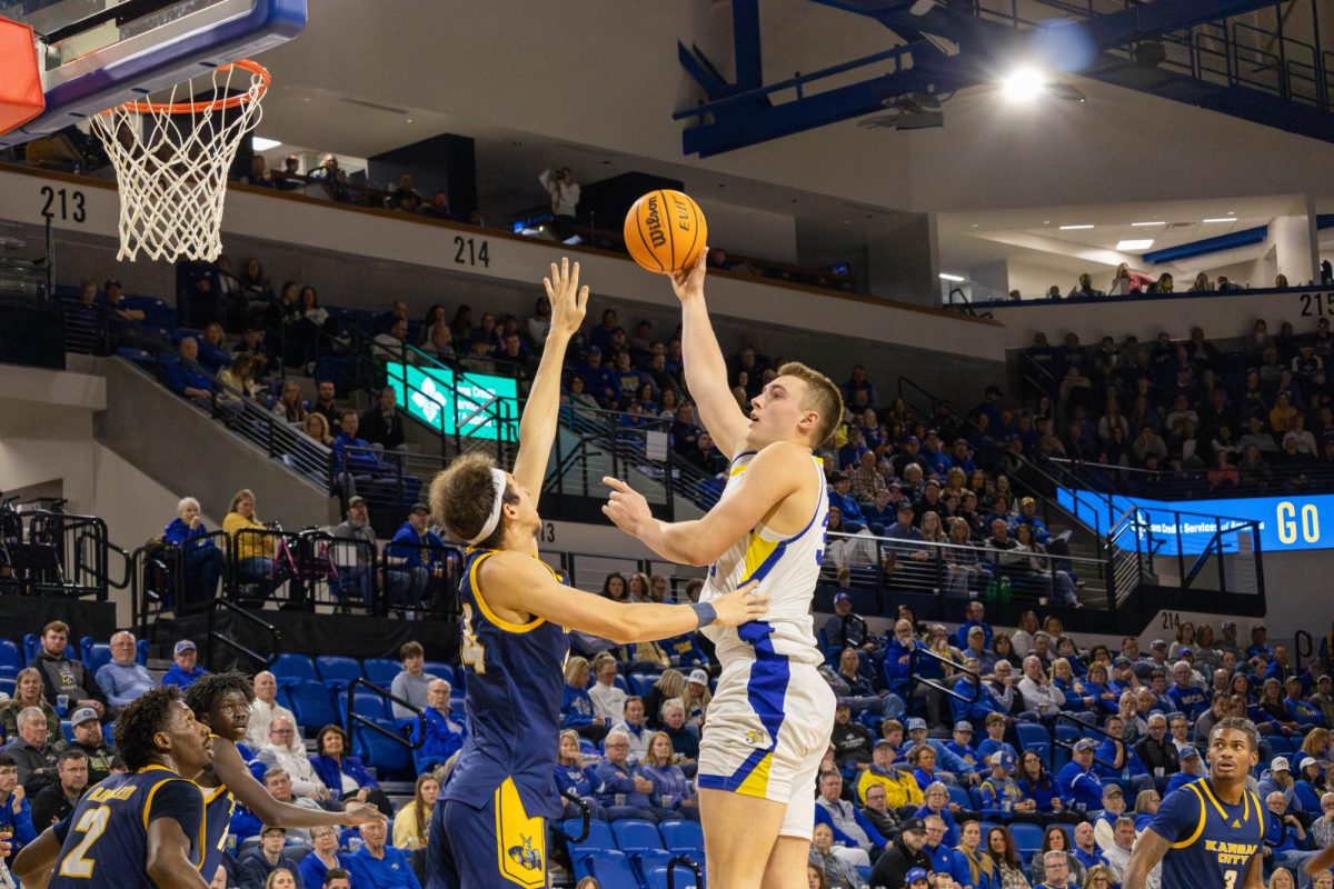 Damon Wilkenson shoots over  Kansas City defender Blake Ammons. The Freshman averages just under five points per game on ten minutes a game.