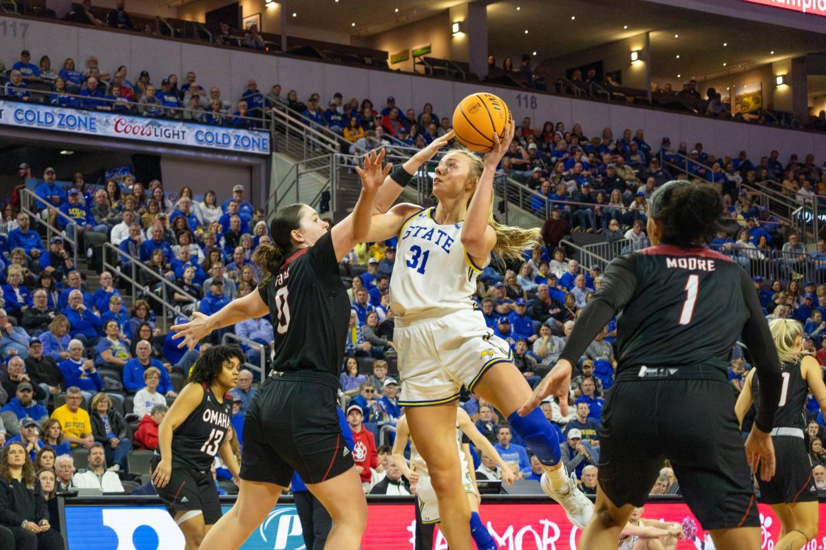 SDSU's Brooklyn Meyer (31) puts a shot up over Omaha's Harriet Ford (0) during the Jackrabbits' 87-67 in the Summit League Championships quarterfinals over Omaha on Thursday at the Denny Sanford PREMIER Center in Sioux Falls.