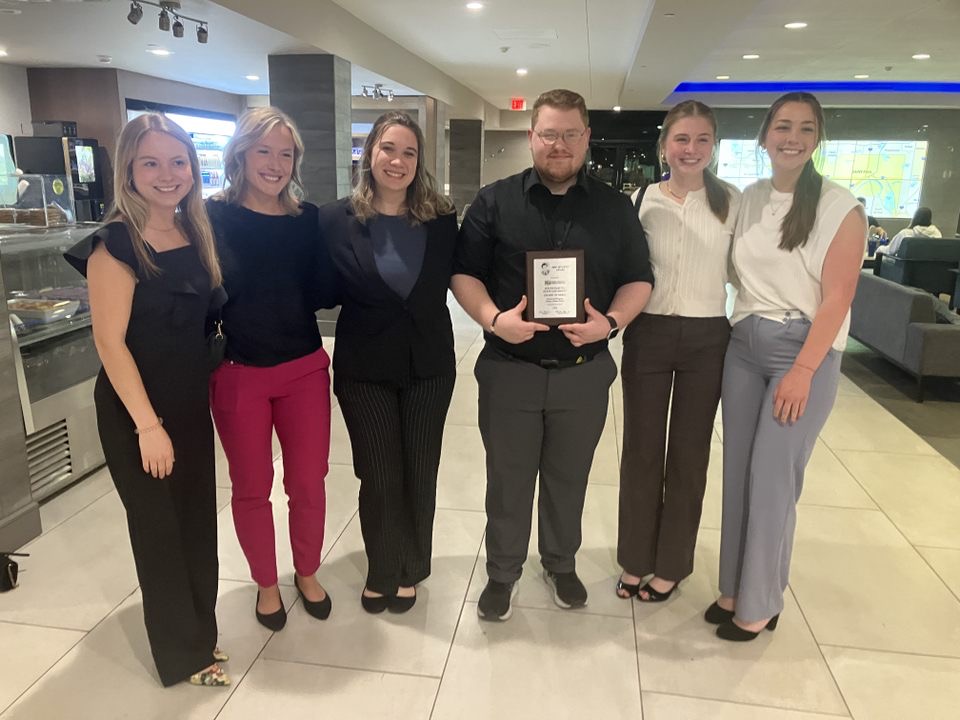 Members of Collegian Media (from left) Ella Stiefvater, Annie Witt, Emily Attrill, Brayden Byers, Ryann Davis and Emily DeCock, pose with the Eric Sevareid Award plaque following the awards banquet on Saturday, April 12, 2025.