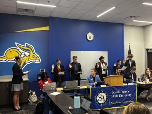 Five new senators-at-large (left) Megan Christoffels, Malachi Swift, Shishir Roka, Supriya Paudel, and Brandon Kampsen are sworn in during the final Students’ Association meeting of the year on April 28.