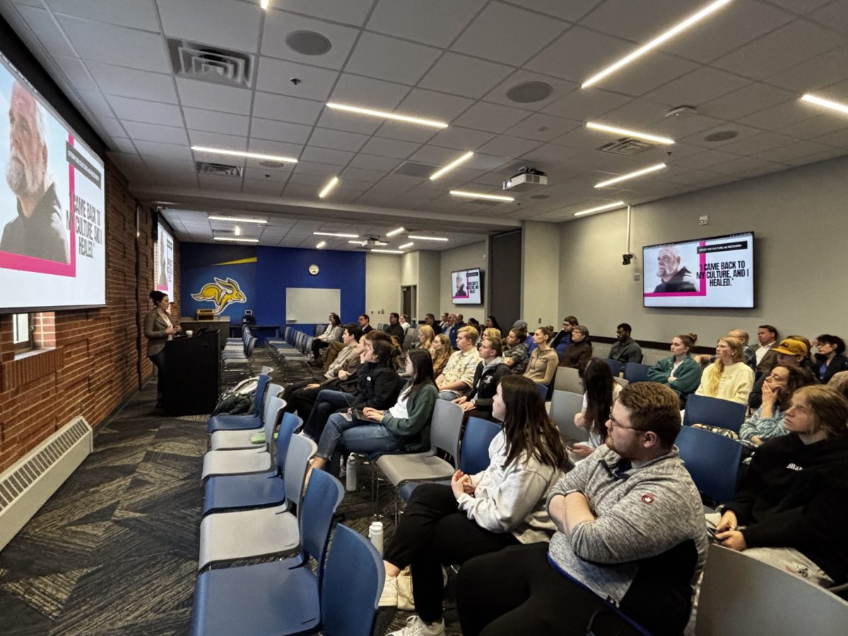 Pulitzer Center grantee Elyse Wild is seen here giving a presentation on her three articles about addiction in Native communities and the efforts to help people struggling with it. She based the three articles she wrote off Native communities in Oregon, Oklahoma and Maine.