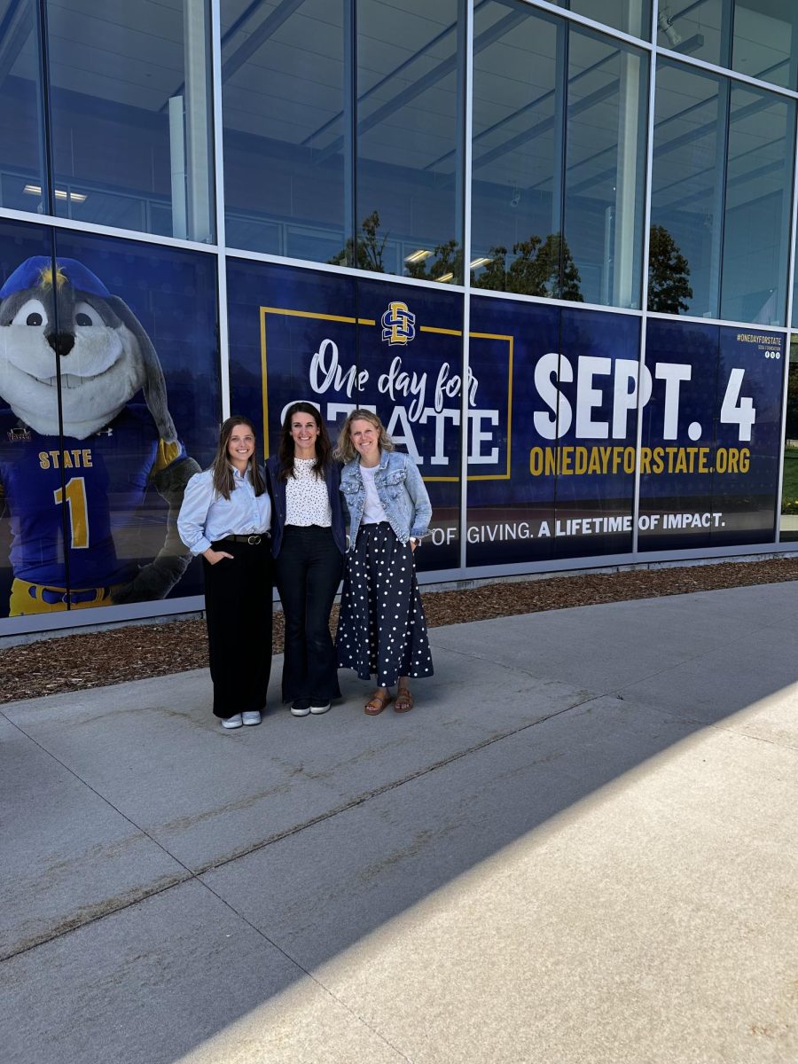 From left to right: Allison Dahl, Jennifer McCloud, Erin Glidden pose in front of the SDSU Alumni Center.
