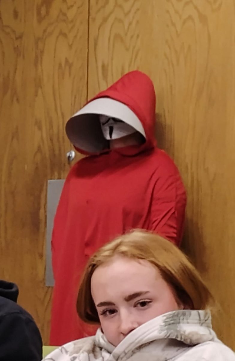 Figures wearing Guy Fawkes masks entered the room and stood by the doors for a time before leaving. 