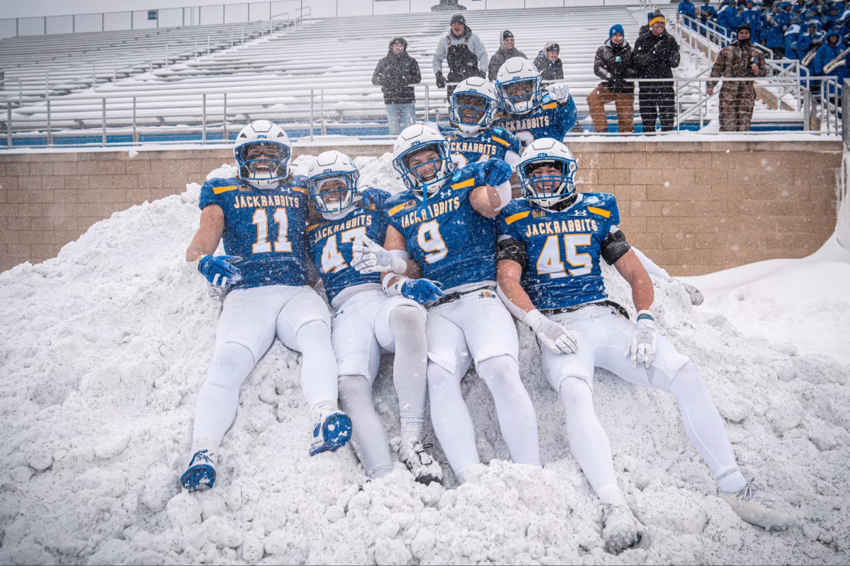 Members of the South Dakota State football team celebrate in a snow pile during an FCS playoff game against New Hampshire on Saturday, Nov. 29, 2025, at Dana J. Dykhouse Stadium in Brookings.