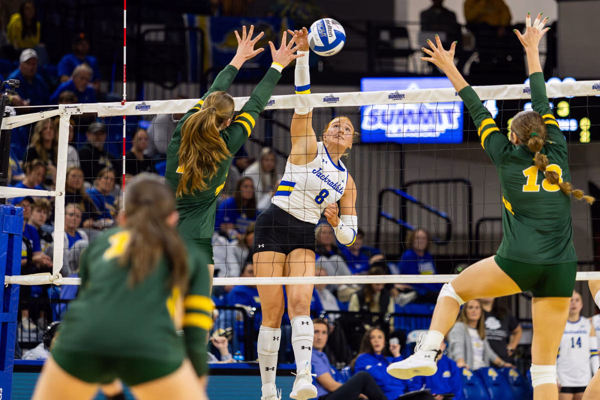 South Dakota State's right-side hitter Madison Burr (8) hits the ball past North Dakota State's Bailey Randall (1) during the third set of a Summit League semifinal match on Monday, Nov. 25, 2025, at First Bank & Trust Arena in Brookings.