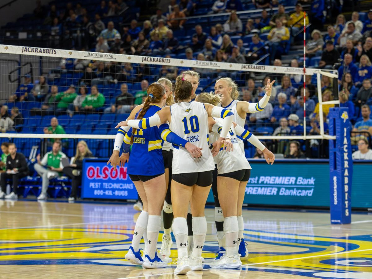 Jackrabbit teammates celebrate after a point against the UND Fighting Hawks on Tuesday, Nov. 18. The Jackrabbits swept the Hawks 3-0 to complete a perfect 16-0 regular season in conference play.