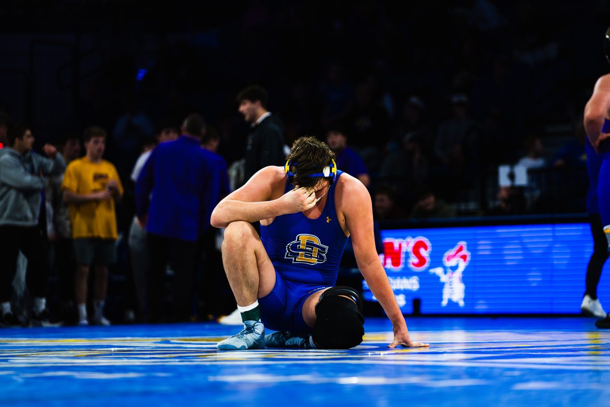 Junior Jackrabbit wrestler Luke Rasmussen sits after a 5-4 loss against UNI wrestler Adam Ahrendsen on Sunday Feb. 8. SDSU ended up taking a 19-13 loss to UNI and dropped their fourth dual.