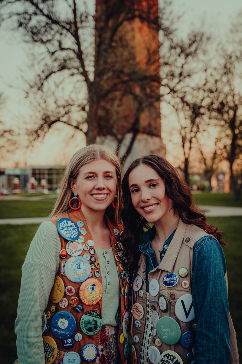 Claire Keonecke (left) and Grace Barnett (right) pose for a photo in front of The Campanile on the South Dakota State University campus. Barnett was selected as the Grand Pooba for the 2026 Hobo Day.