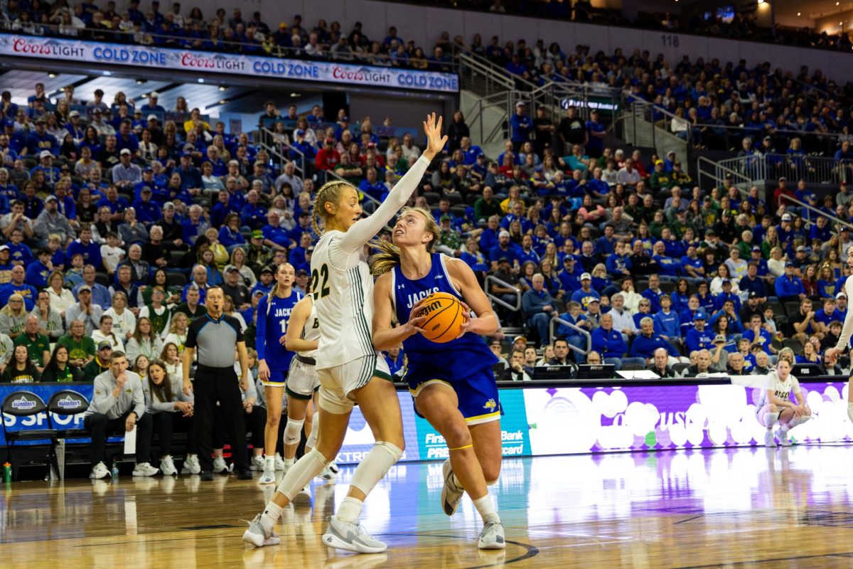 Jackrabbit senior Brooklyn Meyer drives against NDSU’s Avery Koenen in the Summit League Championship game on Sunday March 8, 2025. Meyer helped the Jacks win their fourth straight title, besting the Bison 64-51. In the NCAA Tournament game against the Washington Huskies, Meyer put up 29 points and seven rebounds while shooting 13-20 from the field.