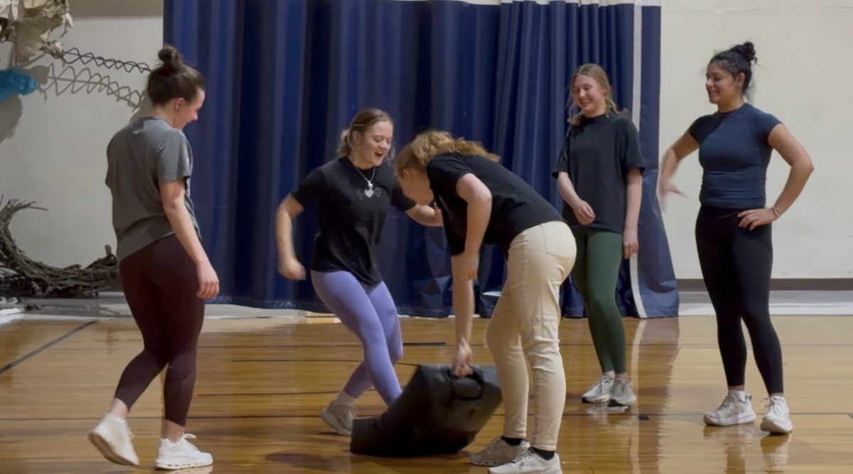 Jasmine Anawski assists students in a self-defense exercise on Thursday, Feb. 26, 2026 in the Barn.