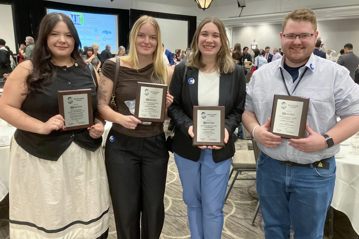 Collegian Media members, from left, Brooke Burnette, Izzy Cox, Emily Attrill and Brayden Byers pose while holding four Eric Sevareid Awards on Saturday, April 11, 2026 at the Midwest Journalism Conference held in St. Paul, Minnesota.