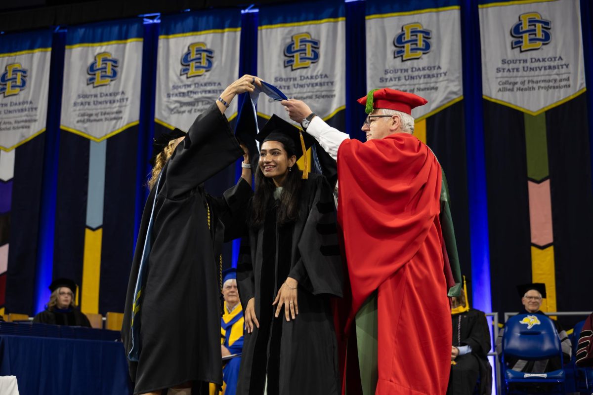 A graduate takes part of a hooding ceremony at South Dakota State graduation ceremony on May 10, 2025 at First Bank and Trust Arena.